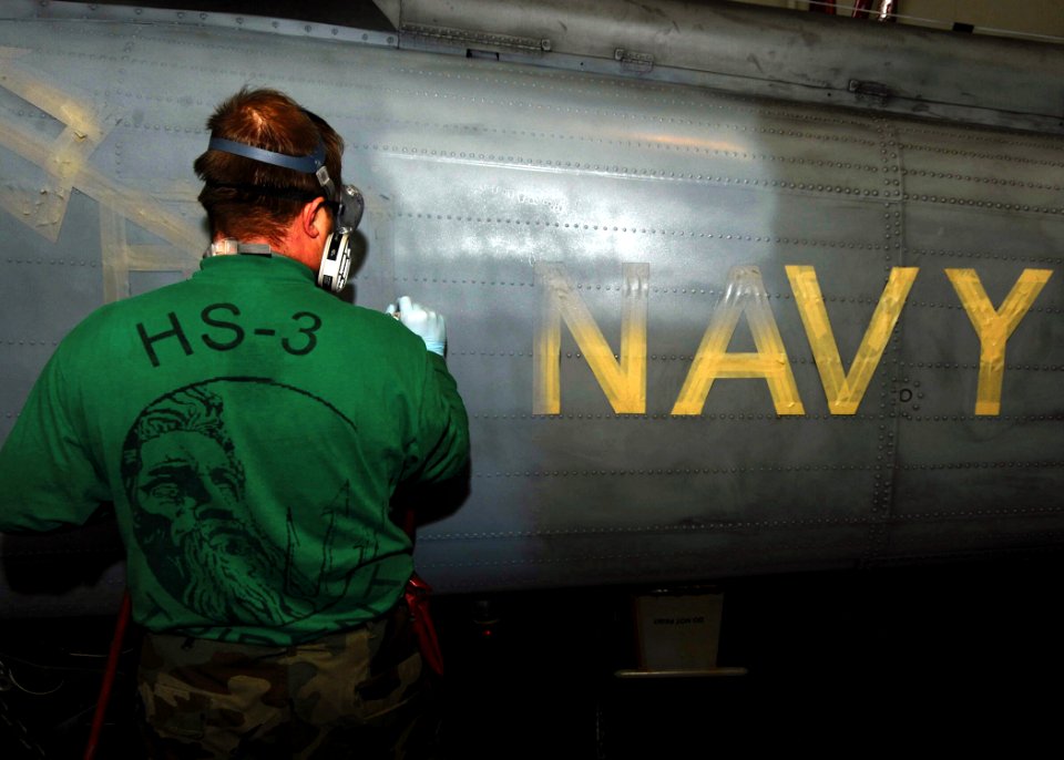 US Navy 090205-N-2908M-003 Aviation Structural Mechanic 1st Class Todd Theobolt paints the tail of an SH-60F helicopter aboard the aircraft carrier USS Theodore Roosevelt (CVN 71)
