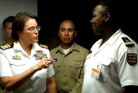 US Navy 090205-N-3316L-028 Capt. Cindy Thebaud, commanding officer of Africa Partnership Station speaks with an embarked trainee during a shipboard indoctrination class aboard the amphibious transport dock ship USS Nashville (L photo