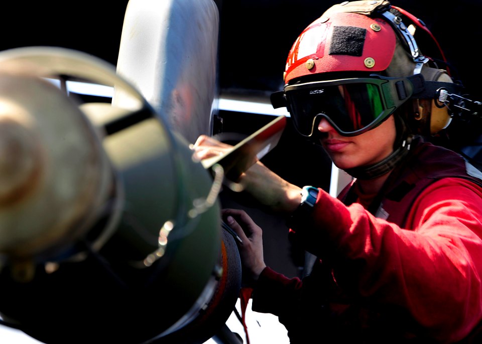 US Navy 090204-N-8822R-187 Aviation Ordnanceman 2nd Class Marie Fentress checks the connection on a GBU-12 Paveway II laser-guided to an F-A-18A- Hornet