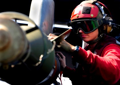 US Navy 090204-N-8822R-187 Aviation Ordnanceman 2nd Class Marie Fentress checks the connection on a GBU-12 Paveway II laser-guided to an F-A-18A- Hornet
