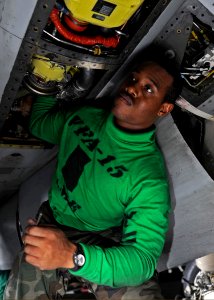 US Navy 090206-N-2908M-003 Aviation Structural Mechanic 2nd Class Eric Manning performs maintenance on an F-A-18 Hornet assigned to the