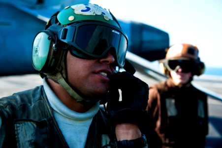 US Navy 111214-N-BT887-251 A Sailor talks to the pilot before a launch