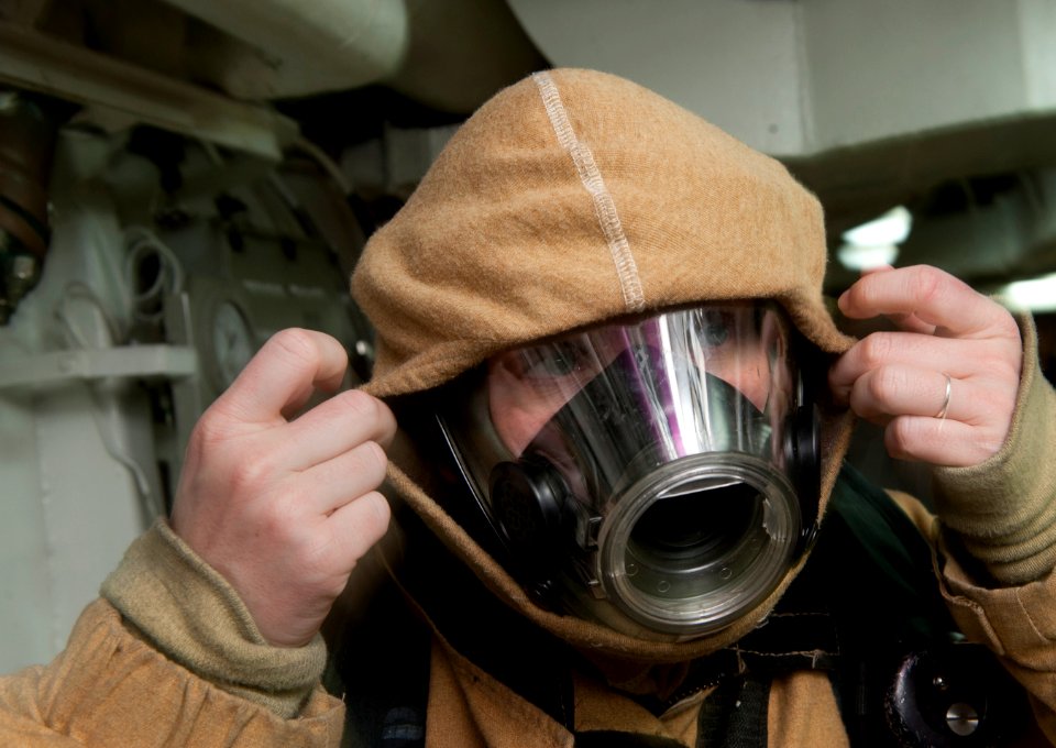 US Navy 120109-N-DR144-096 Machinist's Mate 2nd Class Janice Torres dons a firefighting ensemble