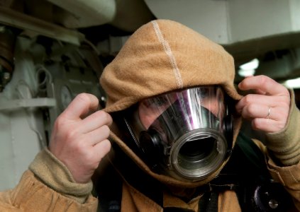 US Navy 120109-N-DR144-096 Machinist's Mate 2nd Class Janice Torres dons a firefighting ensemble