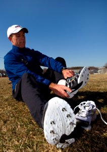 US Navy 090206-N-7090S-137 Cmdr. Scott Jones laces his spikes to test the course at the Armed Forces Championship