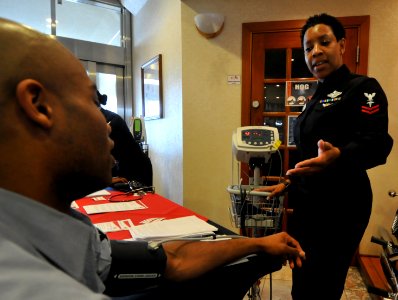 US Navy 090205-N-0807W-026 Hospital Corpsman 2nd Class Genell Cody checks a Sailor's blood pressure during a