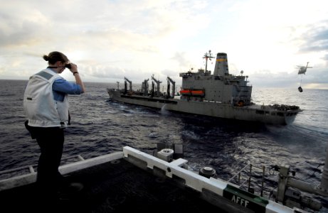 US Navy 090206-N-6538W-021 Quartermaster Seaman Alyssum Richards uses a laser range finder to determine the distance between the aircraft carrier USS John C. Stennis (CVN 74) and the Military Sealift Command fleet replenishment