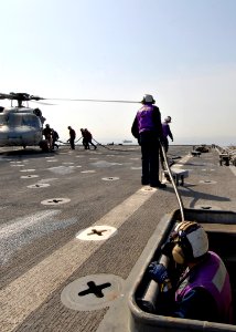 US Navy 090209-N-3392P-045 Sailors aboard the amphibious dock landing ship USS Carter Hall (LSD 50) fuel an MH-60S Sea Hawk Helicopter from Helicopter Sea Combat Squadron (HSC) 26
