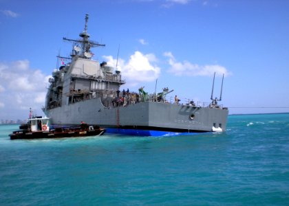 US Navy 090207-N-0000X-007 The Pearl Harbor-based guided-missile cruiser USS Port Royal (CG 73) takes a starboard list as the USNS Salvor (T-ARS 52) tries to free the ship after it ran aground Feb. 5 about a half-mile south of