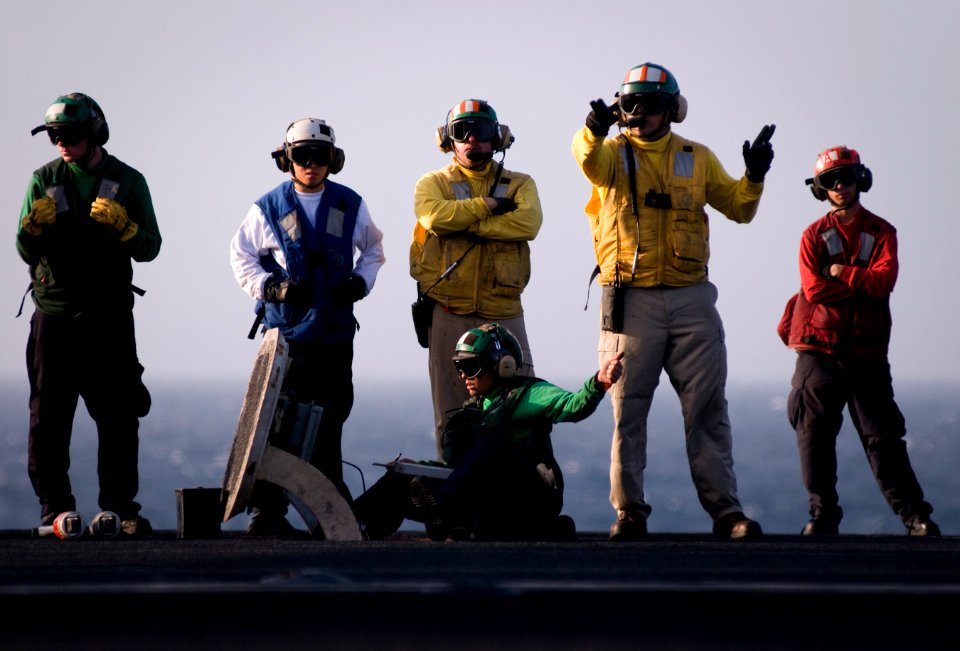 US Navy 120102-N-TZ605-601 A Sailor signals for a final check before launching an aircraft