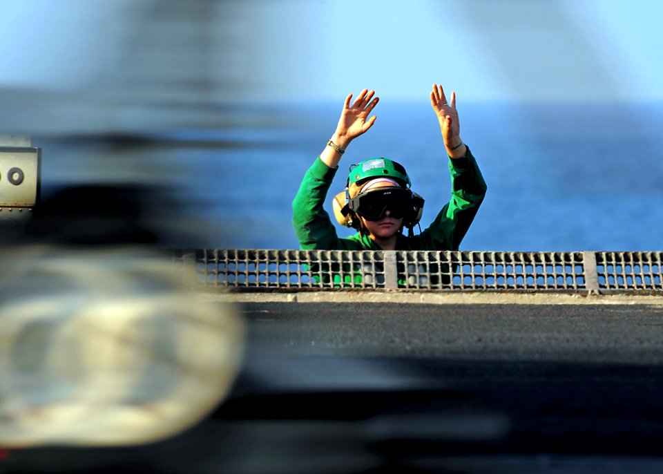 US Navy 090210-N-7571S-011 Aviation Boatswain's Mate (Equipment) 3rd Class Nancy Germann clears her hands from the catapult release button after she releases an aircraft during the first event of flight operations aboard the ai