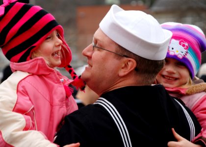 US Navy 111214-N-AW342-132 Sonar Technician Submarine 1st Class Patrick Fonner spends his first moments back from deployment with daughters, Rebecc