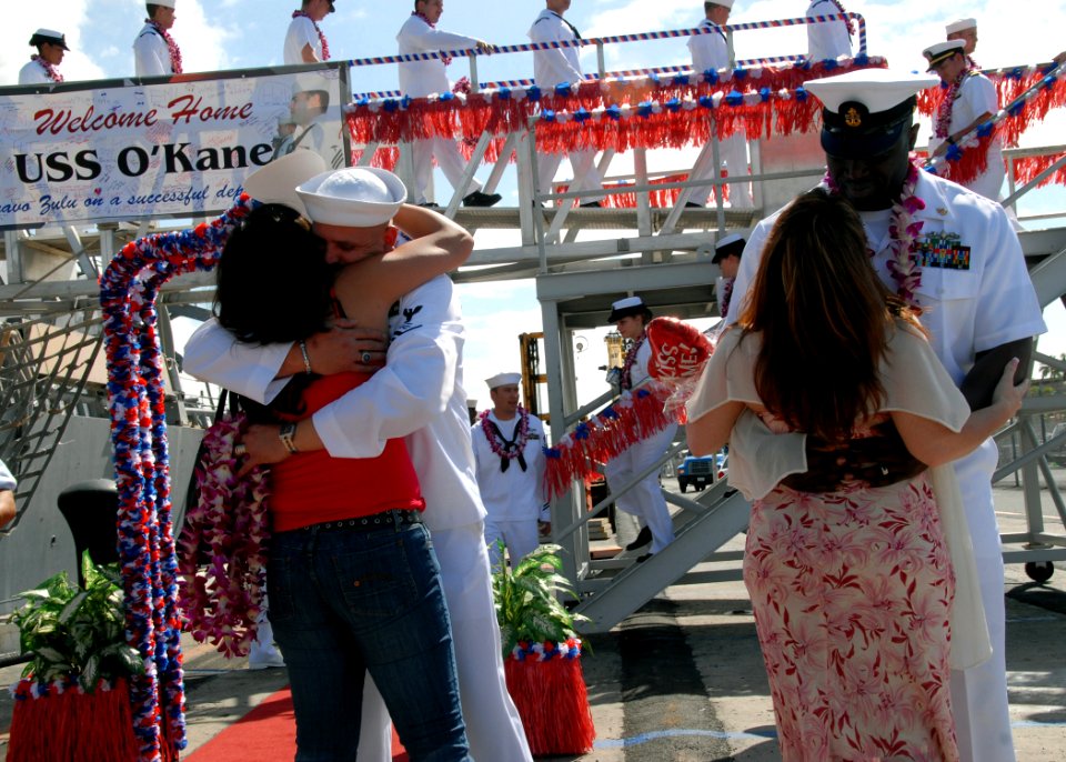 US Navy 090209-N-3666S-047 Sailors assigned to the Arleigh Burke-class guided-missile destroyer USS O'Kane (DDG 77) embrace their loved ones pier side at Naval Station Pearl Harbor
