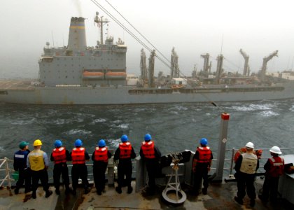 US Navy 090212-N-9134V-001 Sailors aboard the amphibious dock landing ship USS Carter Hall (LSD 50) watch as the Military Sealift Command fleet replenishment oiler USNS Tippecanoe (T-AO 199) comes alongside the ship for a reple