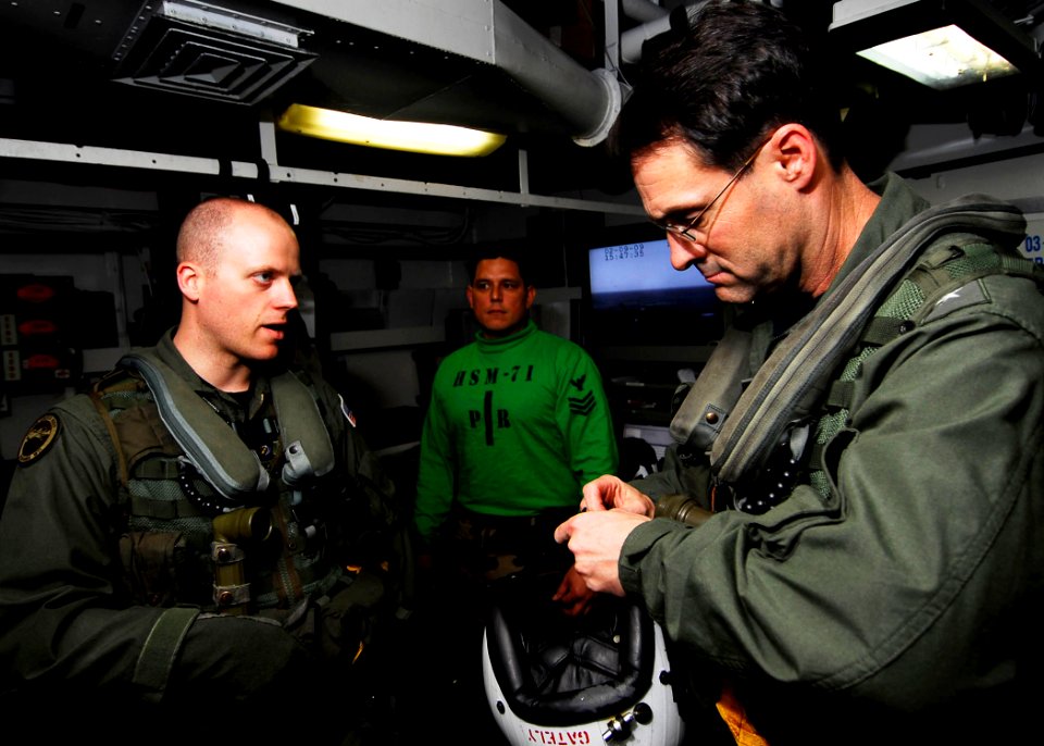 US Navy 090209-N-6538W-300 Naval Air Crewman 1st Class Kelvin Glienke, left, from Webb, Iowa, briefs Commander, U.S. 7th Fleet, Vice Adm. John Bird aboard the Nimitz-class aircraft carrier USS John C. Stennis (CVN 74)