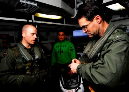 US Navy 090209-N-6538W-300 Naval Air Crewman 1st Class Kelvin Glienke, left, from Webb, Iowa, briefs Commander, U.S. 7th Fleet, Vice Adm. John Bird aboard the Nimitz-class aircraft carrier USS John C. Stennis (CVN 74)