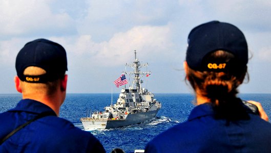 US Navy 090213-N-4774B-050 Sailors aboard the port bridge wing of the guided-missile cruiser USS Lake Champlain (CG 57) observe the guided-missile destroyer USS The Sullivans (DDG 68) during exercises at sea