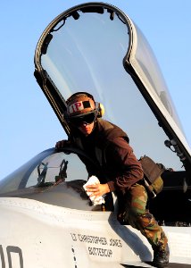 US Navy 090210-N-7571S-016 Aviation Electronics Technician Airman Eric Edwards cleans the canopy of an F-A-18E Super Hornet assigned to the