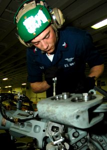 US Navy 090212-N-4236E-028 Aviation Electronics Technician 2nd Class Samuel Gable performs an inspection on an MH-60S Sea Hawk