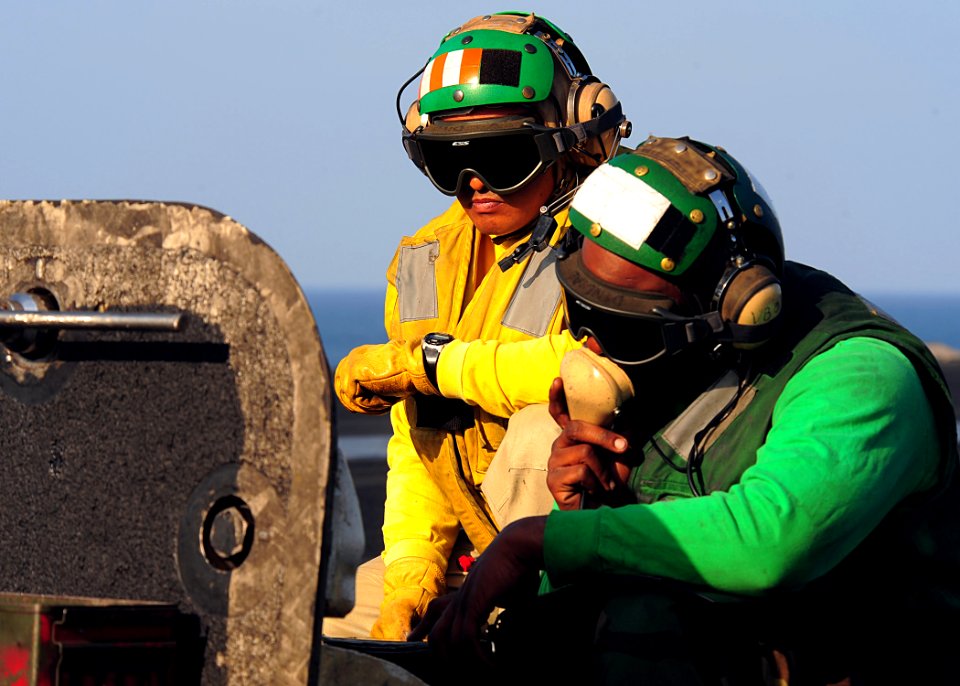 US Navy 090210-N-7571S-015 Lt. Jade Maguigad, left, and Aviation Boatswain's Mate (Equipment) Airman William Fondren prepare aircraft for launch from the aircraft carrier USS Theodore Roosevelt (CVN 71)