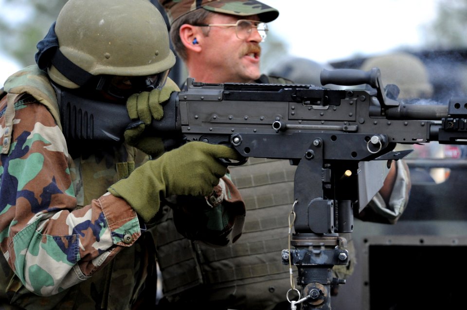 US Navy 090209-N-4205W-005 Barbados Coast Guard Petty Officer 3rd Class Stephen Cox fires an M240B .762 mm machine gun