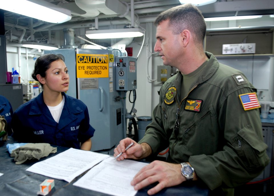 US Navy 090212-N-9520G-011 Lt. David Waner gives positive feed back to Aviation Machinist's Mate Airman Myriam Miller as she completes a spot check