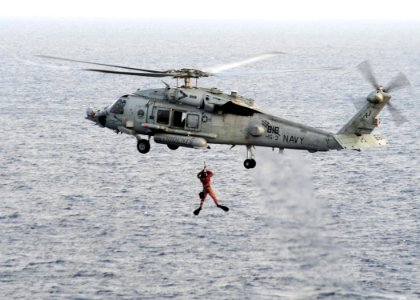 US Navy 090209-N-7571S-002 Explosive Ordnance Disposal Technician 1st Class Bill Pattersons raised into an HH-60H Sea Hawk helicopter photo