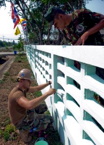 US Navy 090212-N-5253W-034 Construction Mechanic 3rd Class Jeff Schroeder, from Beatty, N.V., left, assigned to Combat Logistics Regiment 3 of the 31st Marine Expeditionary Unit, works with Royal Thai Marines to paint a fence