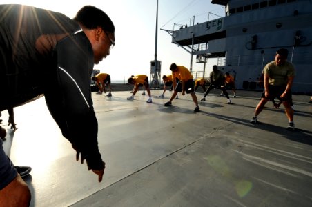 US Navy 090212-N-7280V-053 Seventh Fleet Force Protection Officer Senior Chief Hospital Corpsman Patrick L. Thrift leads a command physical training exercise