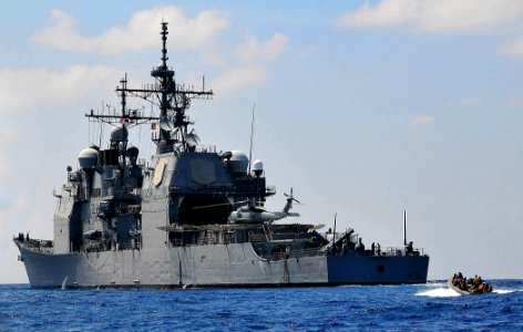 US Navy 090213-N-4774B-159 Members of a visit, board, search, and seizure team assigned to the guided-missile destroyer USS The Sullivans (DDG 68) ride a rigid-hull inflatable boat at high speed during a training exercise photo