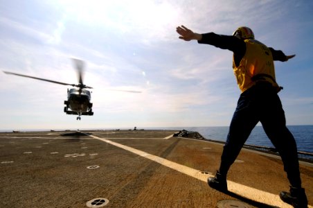 US Navy 090217-N-3830J-180 Boatswain's Mate 2nd Class Nathan D. Macdonald, a Sailor aboard the amphibious command ship USS Blue Ridge (LCC 19), directs an SH-60F Seahawk as it lifts off during a medical evacuation training exe