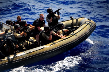 US Navy 090213-N-4774B-167 Members of a visit, board, search, and seizure team assigned to guided-missile cruiser USS Lake Champlain (CG 57) ride a rigid-hull inflatable boat at high speed during a training exercise