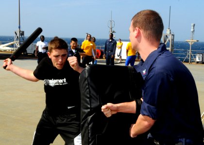 US Navy 090213-N-7280V-015 Seaman Chad Tomes demonstrates a self-defensive baton striking technique aboard the main deck of amphibious command ship USS Blue Ridge (LCC 19)