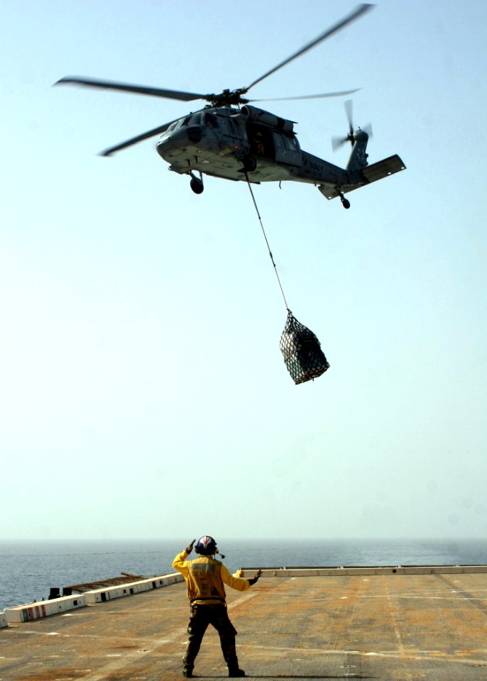 US Navy 090214-N-6764G-078 An MH-60S Sea Hawk helicopter lowers supplies during a vertical replenishment