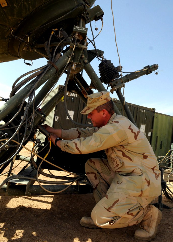 US Navy 090217-N-1120L-008 Information Systems Technician 1st Class Alan Decker, assigned to Naval Mobile Construction Battalion (NMCB) 7, inserts a cord into the transmitter dish of a Ruggedized Deployable Satellite Communicat