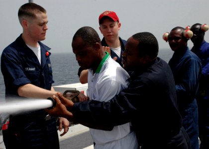 US Navy 090213-N-1655H-020 Africa Partnership Station embarked trainees practice manning a fire hose aboard the amphibious transport dock ship USS Nashville (LPD 13) during damage control training