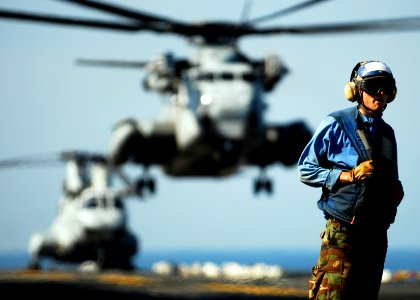 US Navy 090215-N-9950J-101 Aviation Boatswain's Mate Airman (Handling) Patrick Neimeyer stands on the flight deck of the forward-deployed amphibious assault ship USS Essex (LHD 2) photo