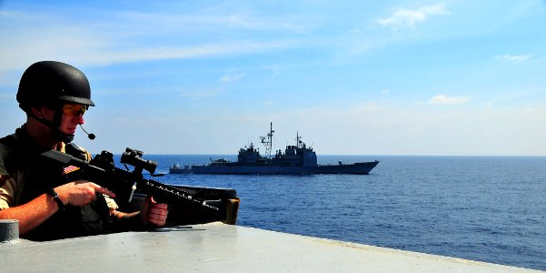 US Navy 090213-N-4774B-089 A member of a visit, board, search, and seizure team stands lookout watch aboard The guided-missile destroyer USS The Sullivans (DDG 68)
