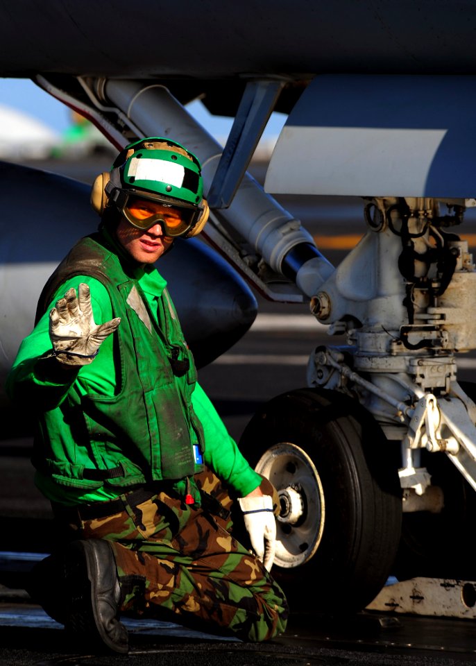 US Navy 090216-N-7571S-013 Aviation Boatswain's Mate (Equipment) 2nd Class Marc Rohloff waits for the signal from an Aviation Boatswain's Mate (Handling) to apply tension before an aircraft launch aboard the aircraft carrier US