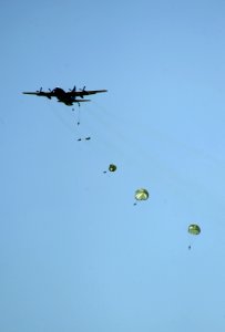 US Navy 090218-N-2959L-018 SEAL Qualification Training students parachute out of a C-130 Hercules military transport aircraft
