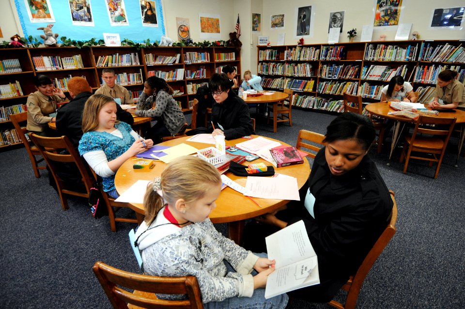 US Navy 090214-N-5328N-036 Information Systems Technician Seaman Aprentice Ashley Lumas, from New Orleans, listens as a West Pensacola Elementary School Saturday Scholar student reads out loud