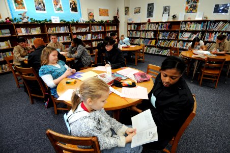 US Navy 090214-N-5328N-036 Information Systems Technician Seaman Aprentice Ashley Lumas, from New Orleans, listens as a West Pensacola Elementary School Saturday Scholar student reads out loud