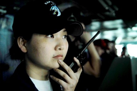 US Navy 090217-N-9610C-041 Storekeeper 2nd Class Grace Wu listens to radio traffic while translating the Cantonese language for the bridge crew