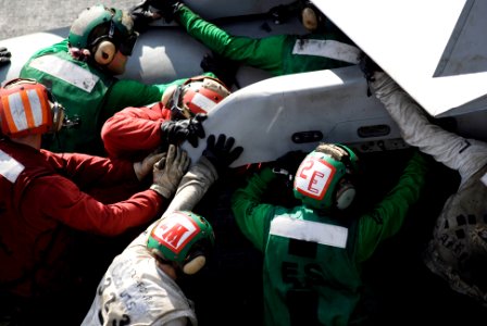 US Navy 090215-N-8157C-832 Flight deck personnel push an F-A-18C strike fighter assigned to the