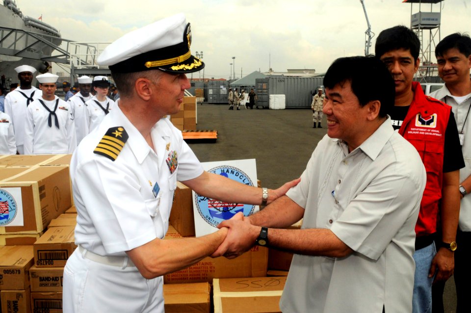 US Navy 090219-N-7280V-089 Capt. Thom W. Burke turns over Project Handclasp materials to Marcelo Nicomedes J. Castillo