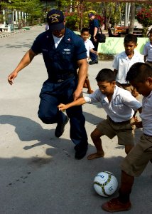 US Navy 090220-N-1251W-008 Fire Controlman 2nd Class Travius Caldwell plays soccer with students from the Ban Klong Sai School