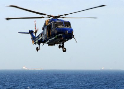 US Navy 090217-N-1082Z-043 A Danish Lynx SH-14C helicopter assigned to the Danish flexible support ship HDMS Absalon (L 16), conducts a personnel transfer with the guided-missile cruiser USS Vella Gulf (CG 72)