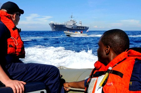 US Navy 090218-N-3830J-596 Ensign Claud W. Sterling and Boatswain's Mate Seaman Walter Johnson, both assigned to the amphibious command ship USS Blue Ridge (LCC 19), look back at fellow crew member's trailing in a rigid hull in