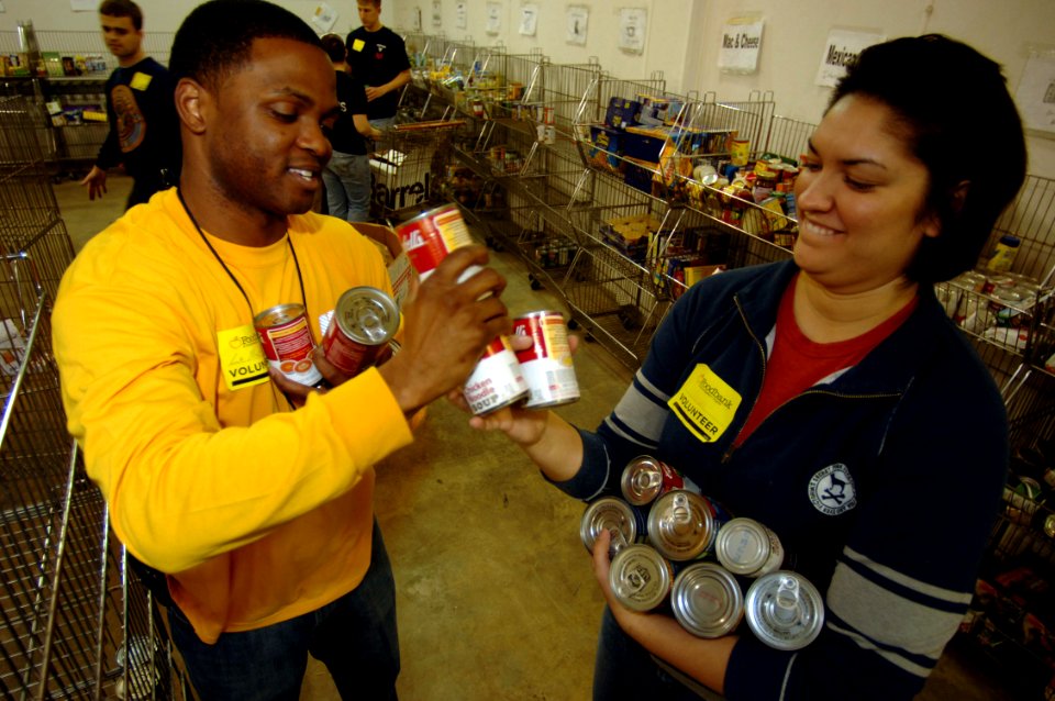 US Navy 090219-N-7544A-109 Air Traffic Controller 2nd Class Lamar Jones and Air Traffic Controller 3rd Class Allison Hamm sort through canned goods at The Food Bank of Southeastern Virginia