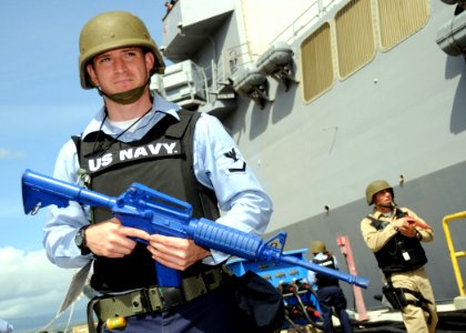 US Navy 090219-N-9758L-255 Electronics Technician 3rd Class Jarred Monju patrols the pier of Naval Station Pearl Harbor during an anti-terrorism force protection drill
